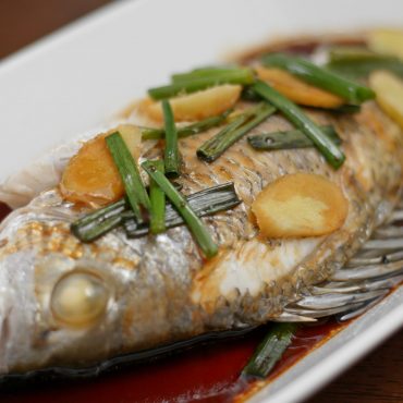 Steamed fish on dish at home